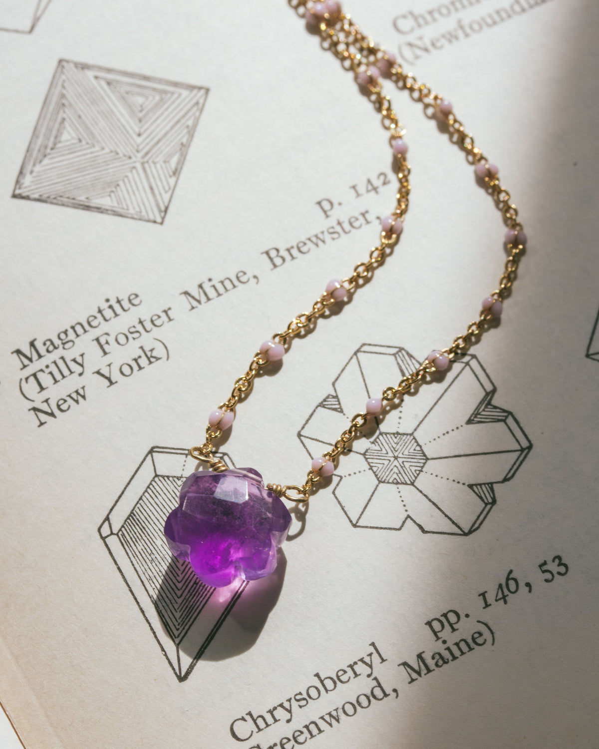 Gold necklace with a purple amethyst floral shaped crystal pendant