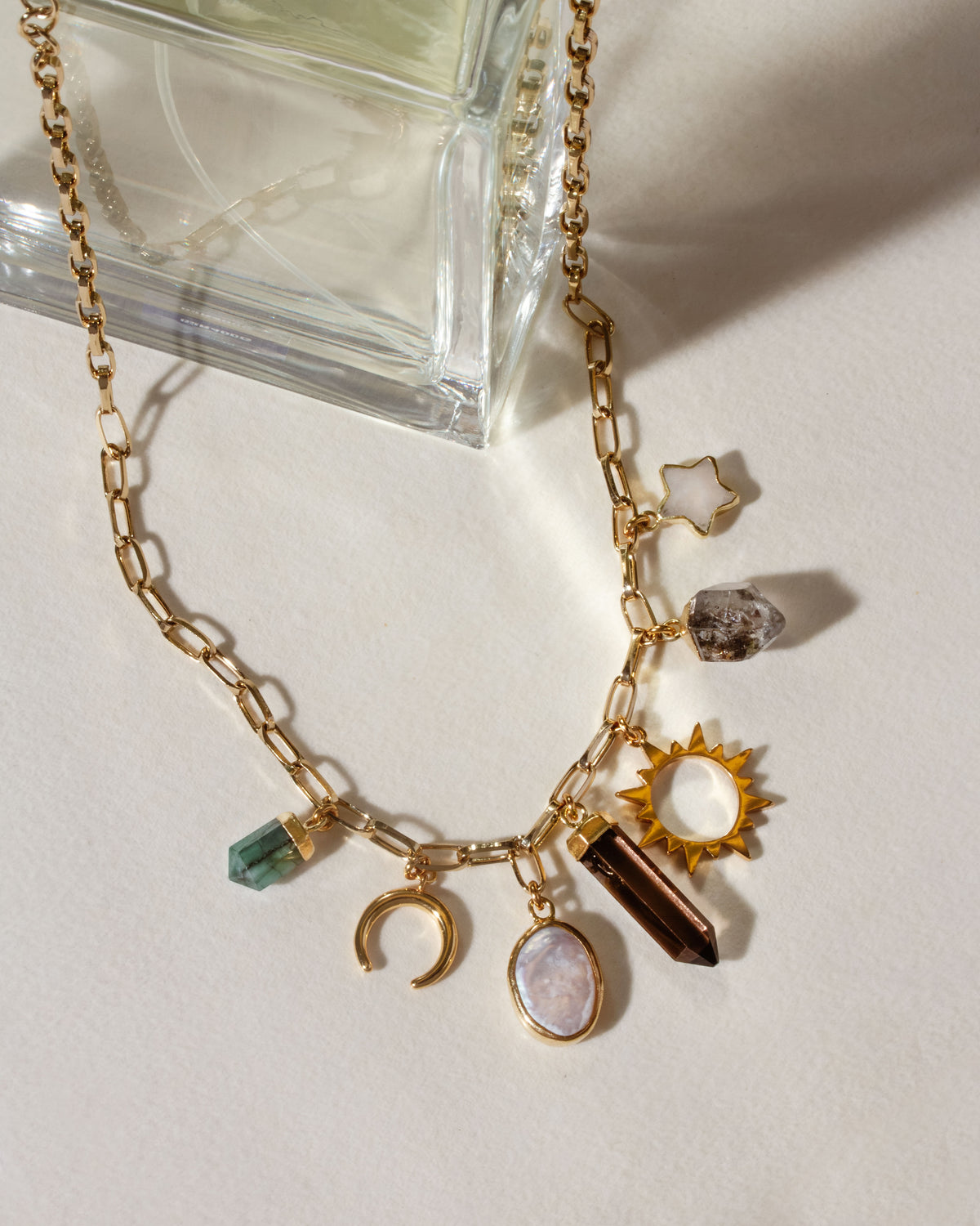 Earthly Treasures necklace with pearl, emerald, smoky quartz, Herkimer quartz, and moonstone charms