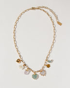 Gold charm necklace with mother-of-pearl, rose quartz, and aquamarine gemstones.