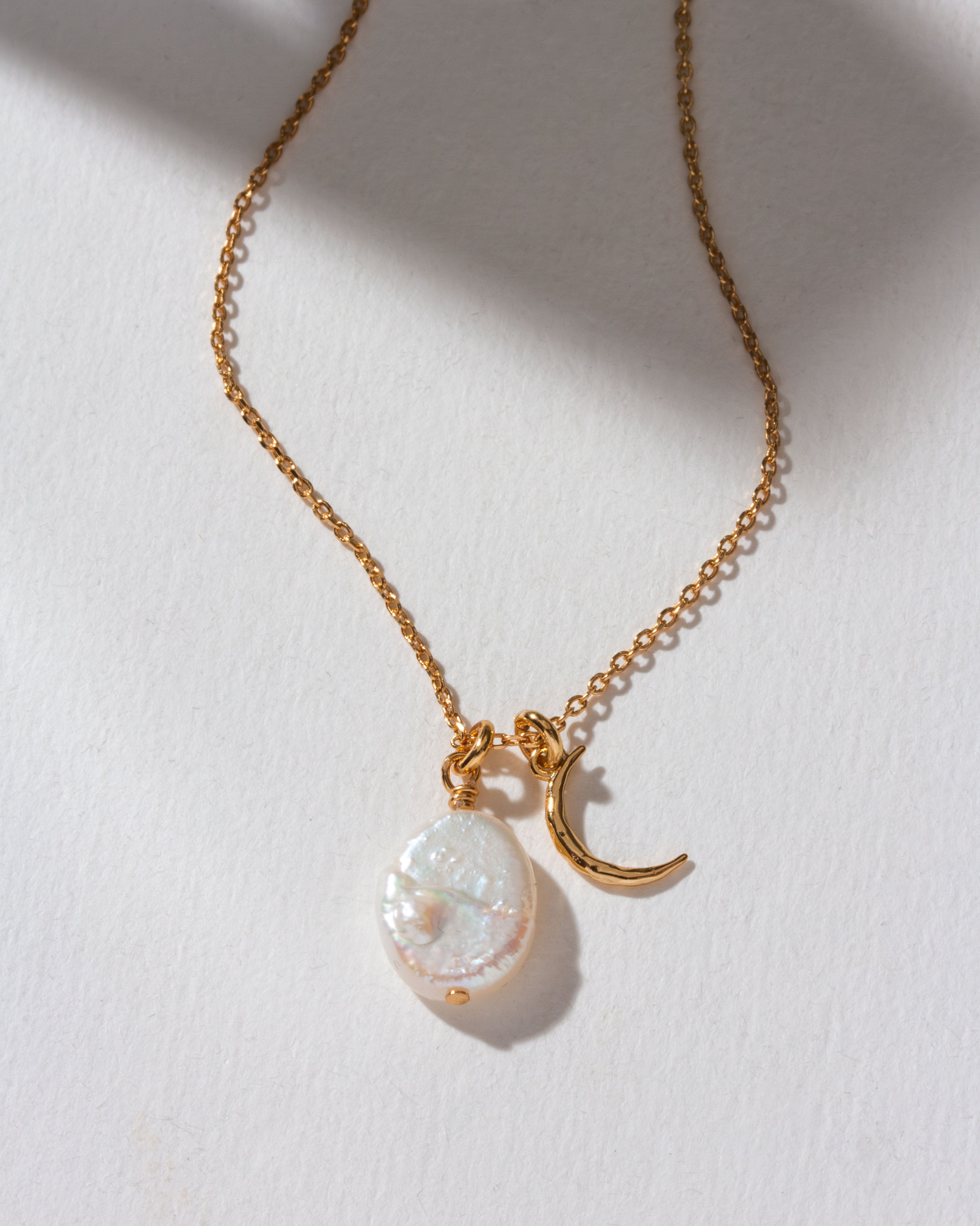 Gold necklace with Freshwater Pearl and crescent moon charm.