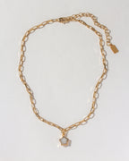 Gold paperclip chain necklace with a moonstone star pendant.