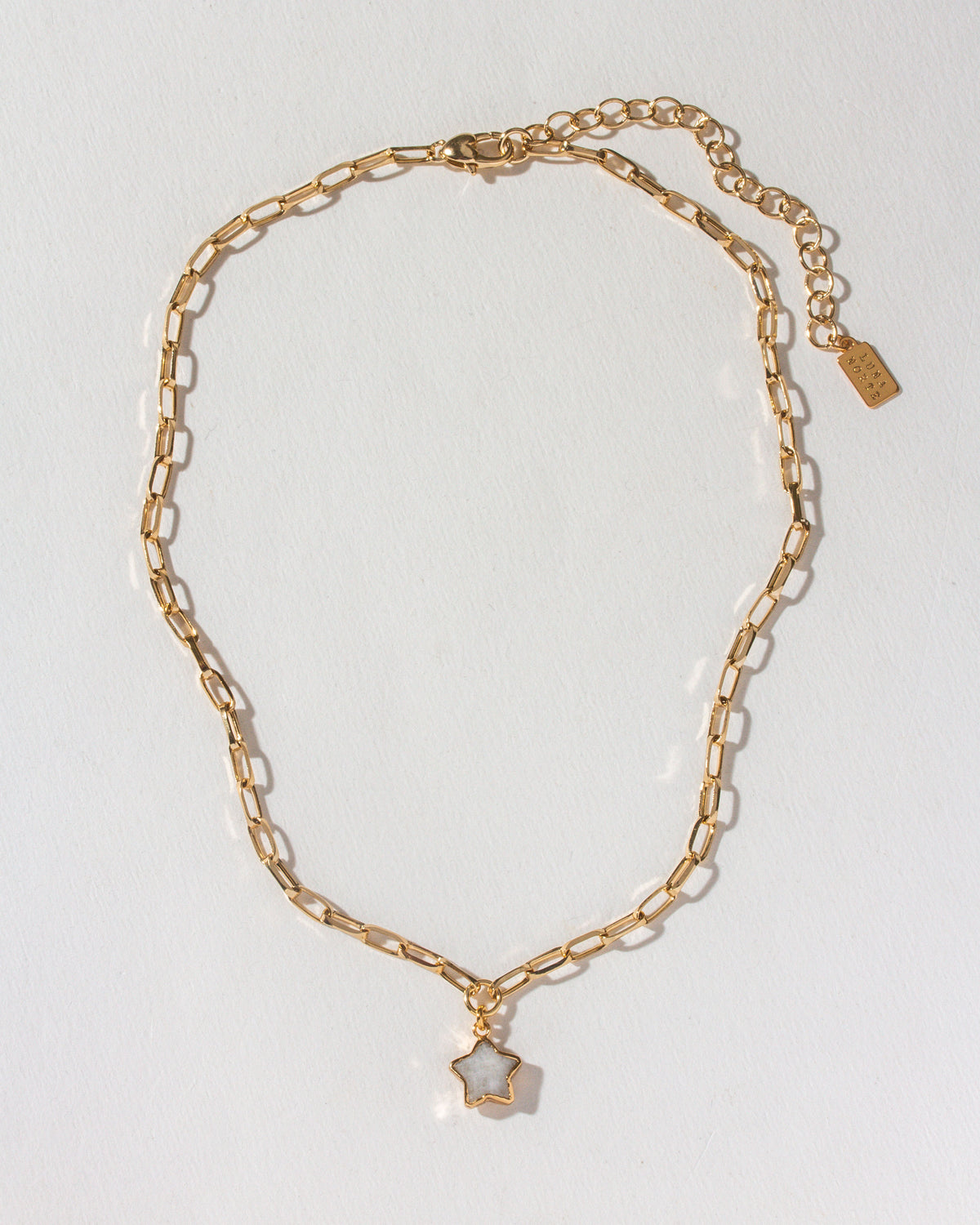 Gold paperclip chain necklace with a moonstone star pendant.