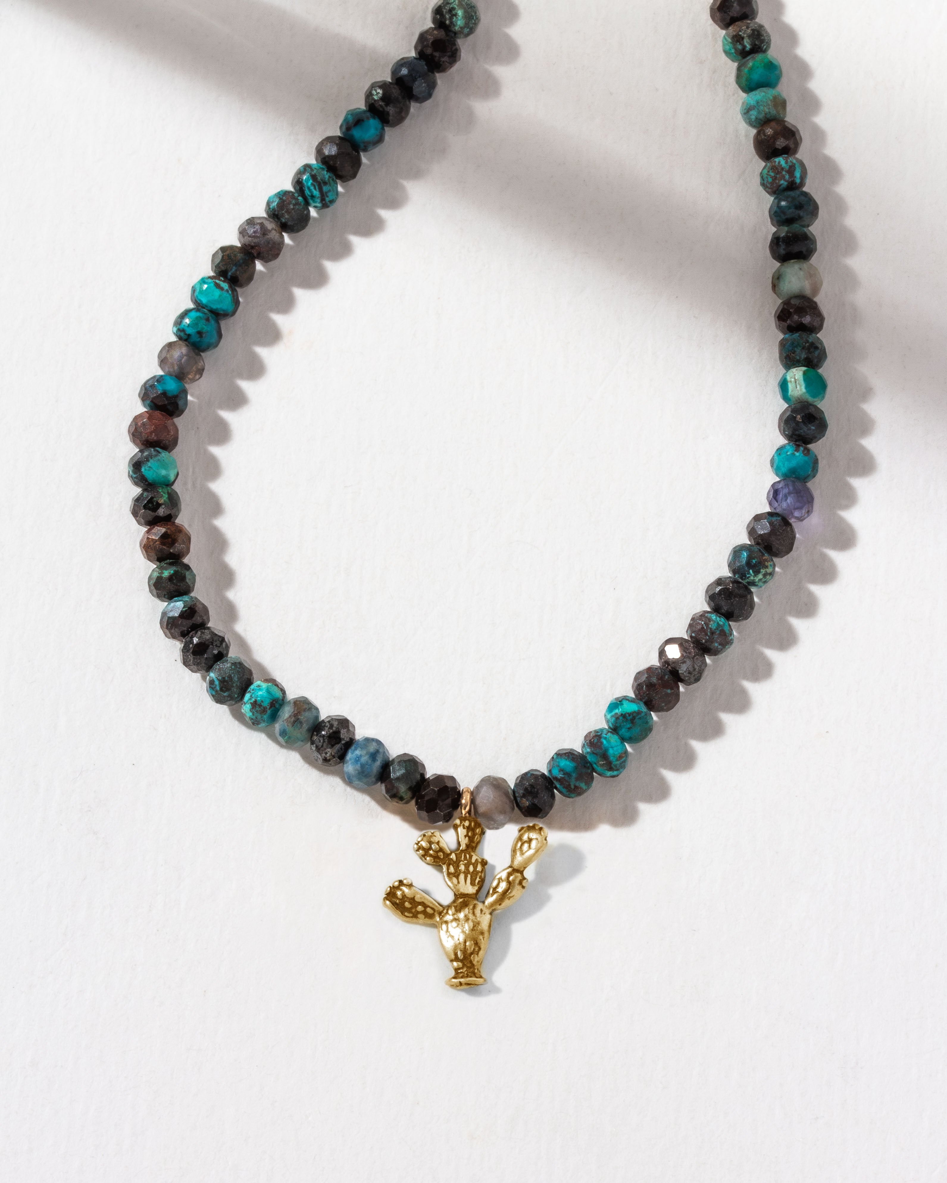 Necklace with black and blue Chrysocolla beads and a golden prickly pear cactus charm