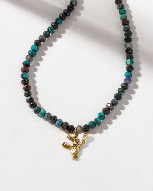 Necklace with black and blue Chrysocolla beads and a golden prickly pear cactus charm