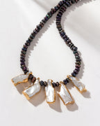 Freshwater pearl necklace with gold-plated keshi pearls and navy hue beads.