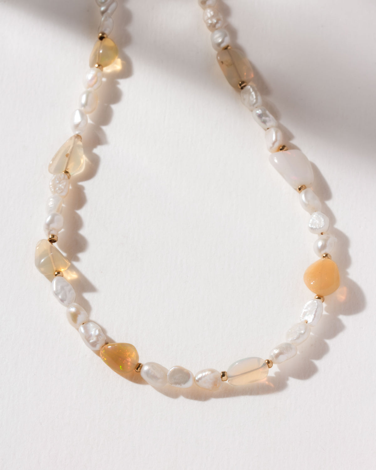 Necklace featuring lustrous freshwater pearls interspersed with iridescent opal beads.