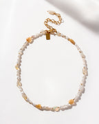 Necklace featuring freshwater pearls and interspersed iridescent opal beads.