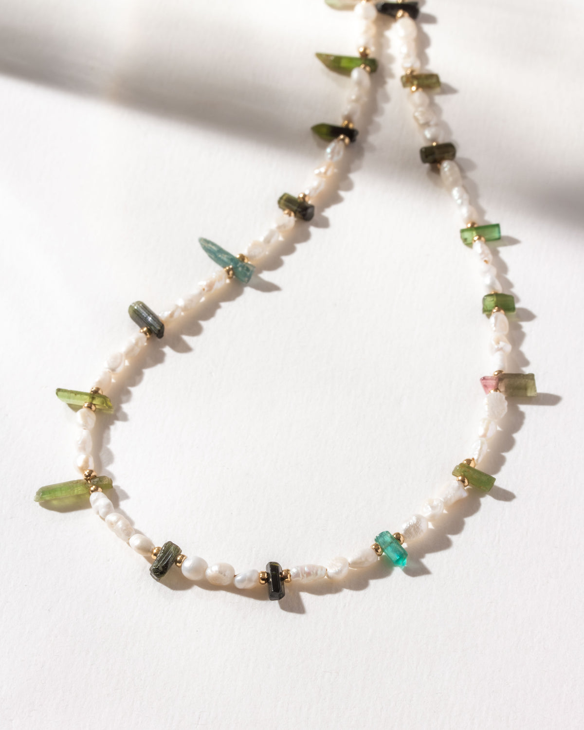 Pearl beaded necklace with light and dark watermelon tourmaline stones.
