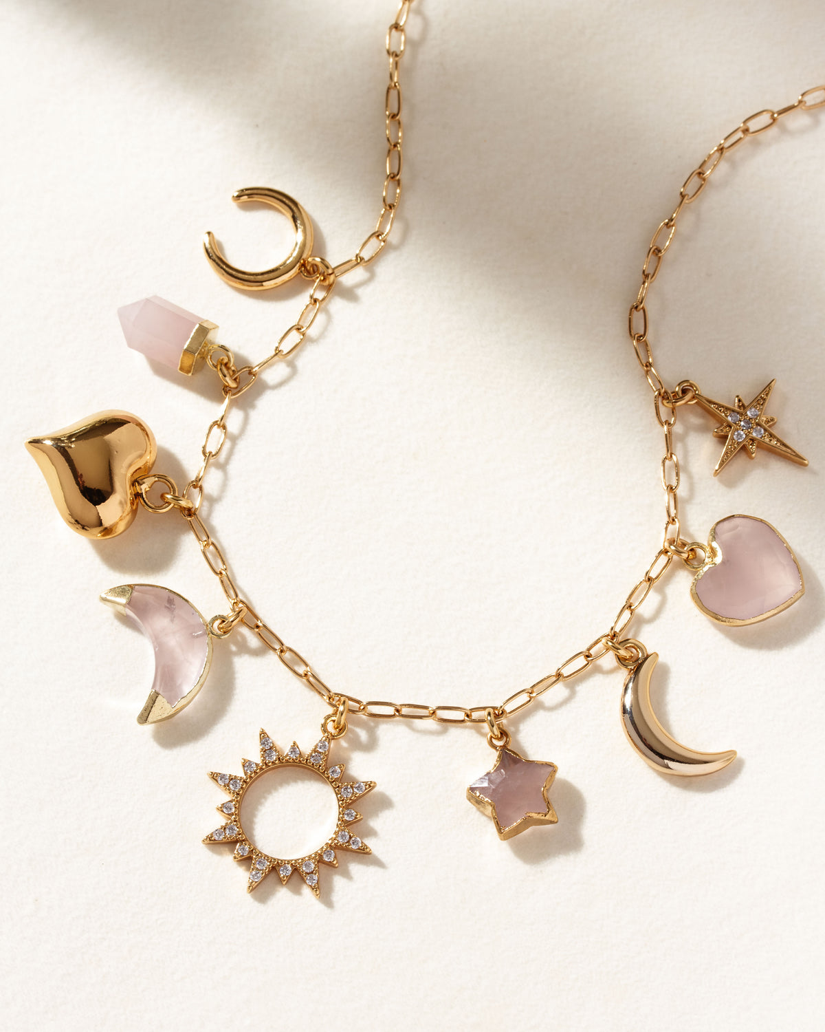 Love and Light Charm Necklace with rose quartz, heart, sun, moon and star charms.