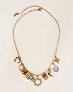 Gold necklace, with rainbow moonstone, an amazonite star, a strawberry quartz heart, and coin pearl.