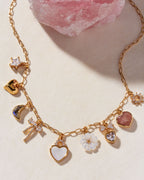Gold charm necklace with mother-of-pearl heart, labradorite moon, and floral charms