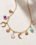 Starlit Trail Charm Necklace with Amethyst, Onyx, and Multistone charms on a gold paperclip chain.