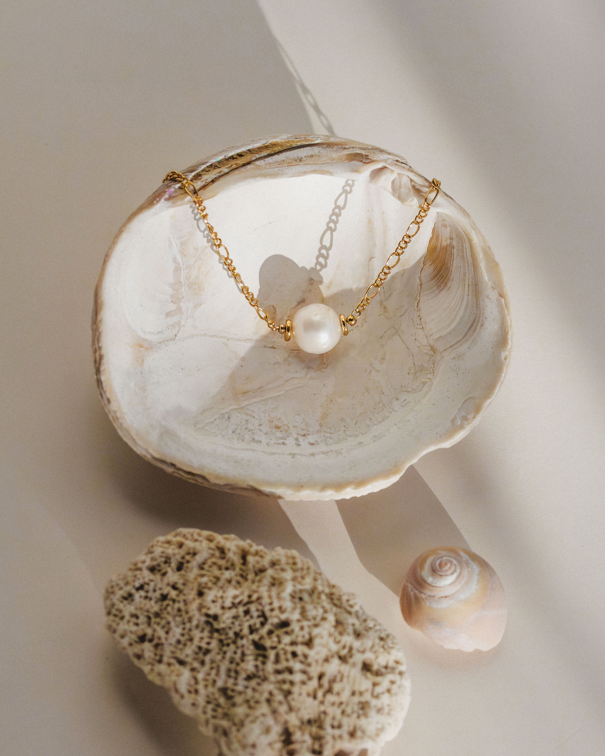 Single-strand gold Barely There Pearl Necklace with shells and a pink pearl