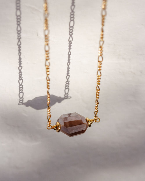 A gold Barely There Gemstone Necklace with a coffee moonstone pendant