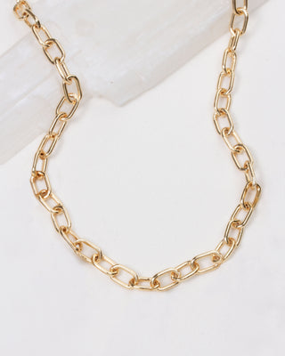Gold chain necklace on a white background