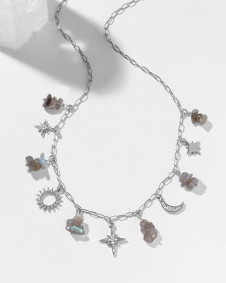 Silver necklace with various cz charms and  labradorite beads on a white background.