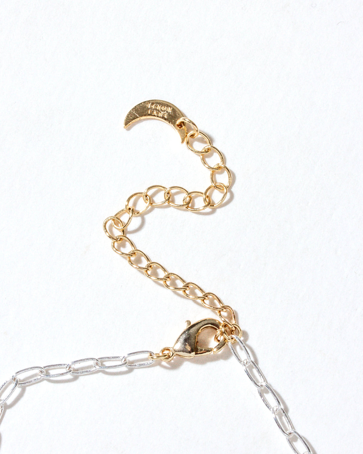 Close-up of the Herkimer Horizon Charm Necklace's clasp and gold extender chain