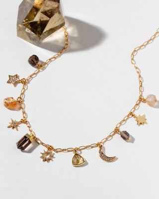 Gold necklace with various CZ, Smoky Quartz, and Citrine charms on a white background