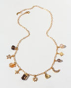 Gold necklace with various CZ, Smoky Quartz, and Citrine charms on a white background