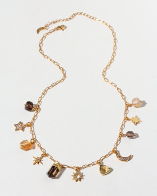 Gold necklace with various CZ, Smoky Quartz, and Citrine charms on a white background