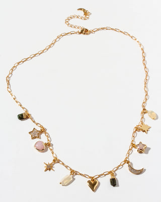 Gold necklace with various charms on a white background