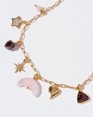 Gold chain necklace with star, heart, and crescent moon charms on a white background