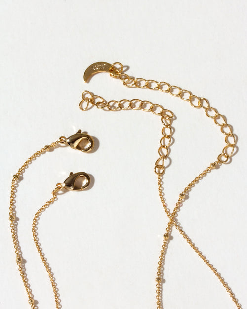 Closeup of Gold chain necklace set lobster clasps on a white background