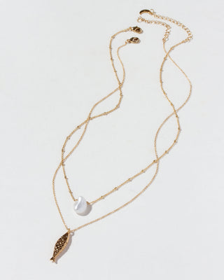 Gold necklace set with a fish and keshi pearl pendants on a white background
