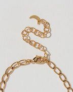 Gold chain necklace extender chain on a light gray background