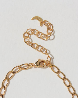 Gold chain necklace extender chain on a light gray background