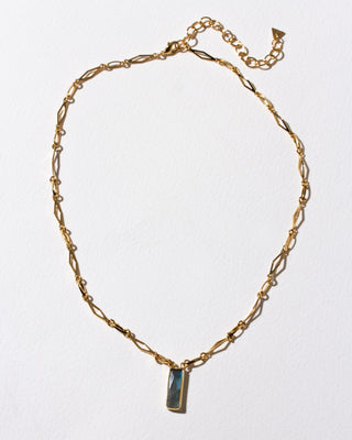 Gold chain necklace with a rectangular labradorite pendant.