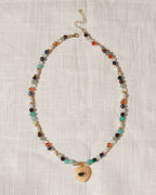Multicolor faceted gemstone beaded necklace with yellow calcite heart centered with eye shaped CZ center.