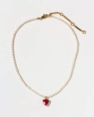 Pearl necklace with a red inverted triangle pendant on a white background