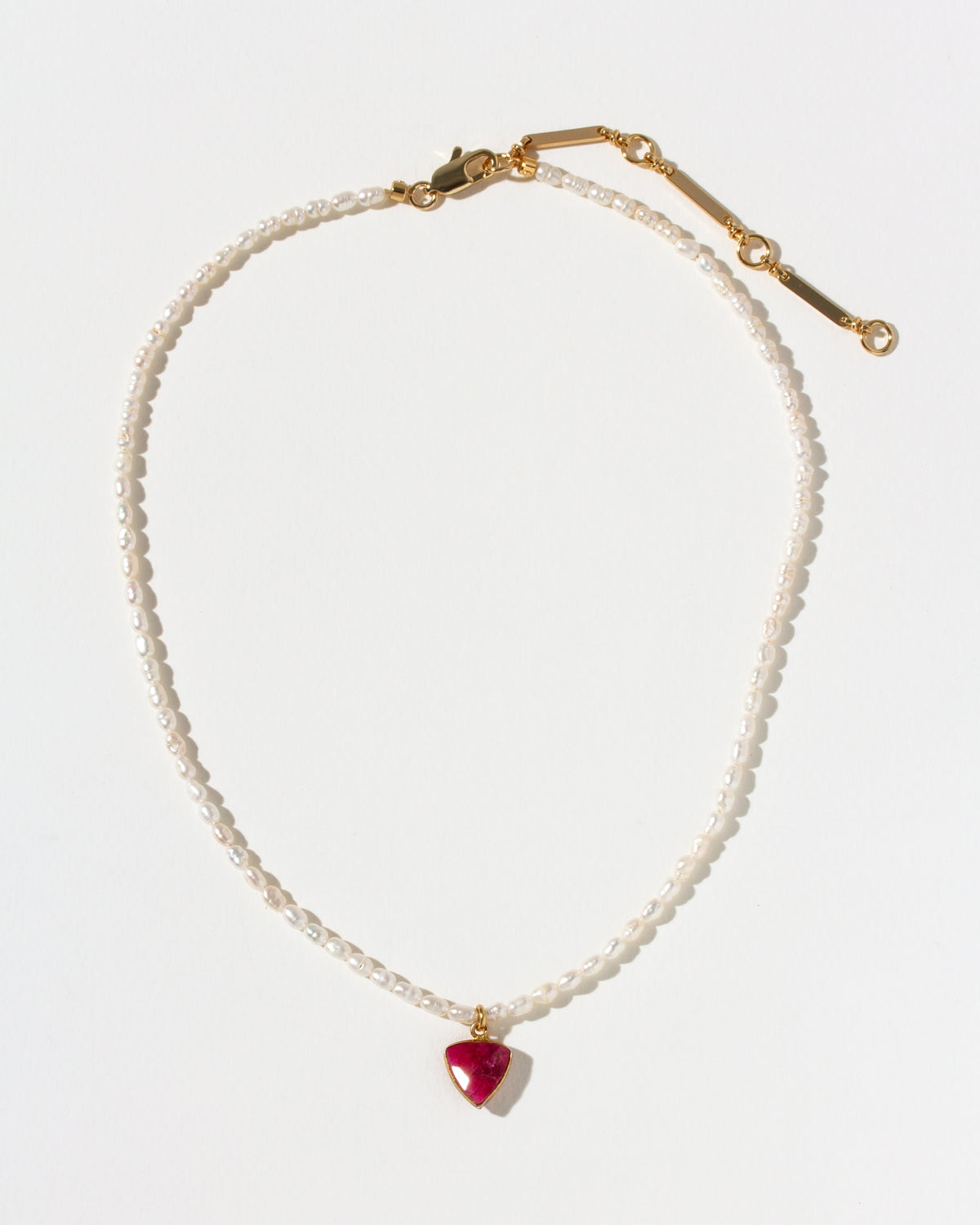 Pearl necklace with a red inverted triangle pendant on a white background