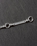 Silver detail of Luna Norte extender chain on a dark background