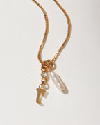 Gold box chain necklace with a dangling letter J charm, a small crystal, and an long pearl.