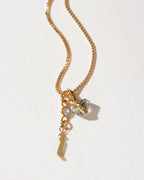 Gold necklace with I charm, crystal, and Herkimer quartz.