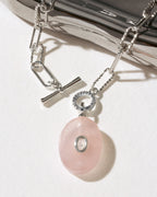 Silver plated paperclip toggle front necklace with pink rose quartz oval pendant with clear center bezeled stone.