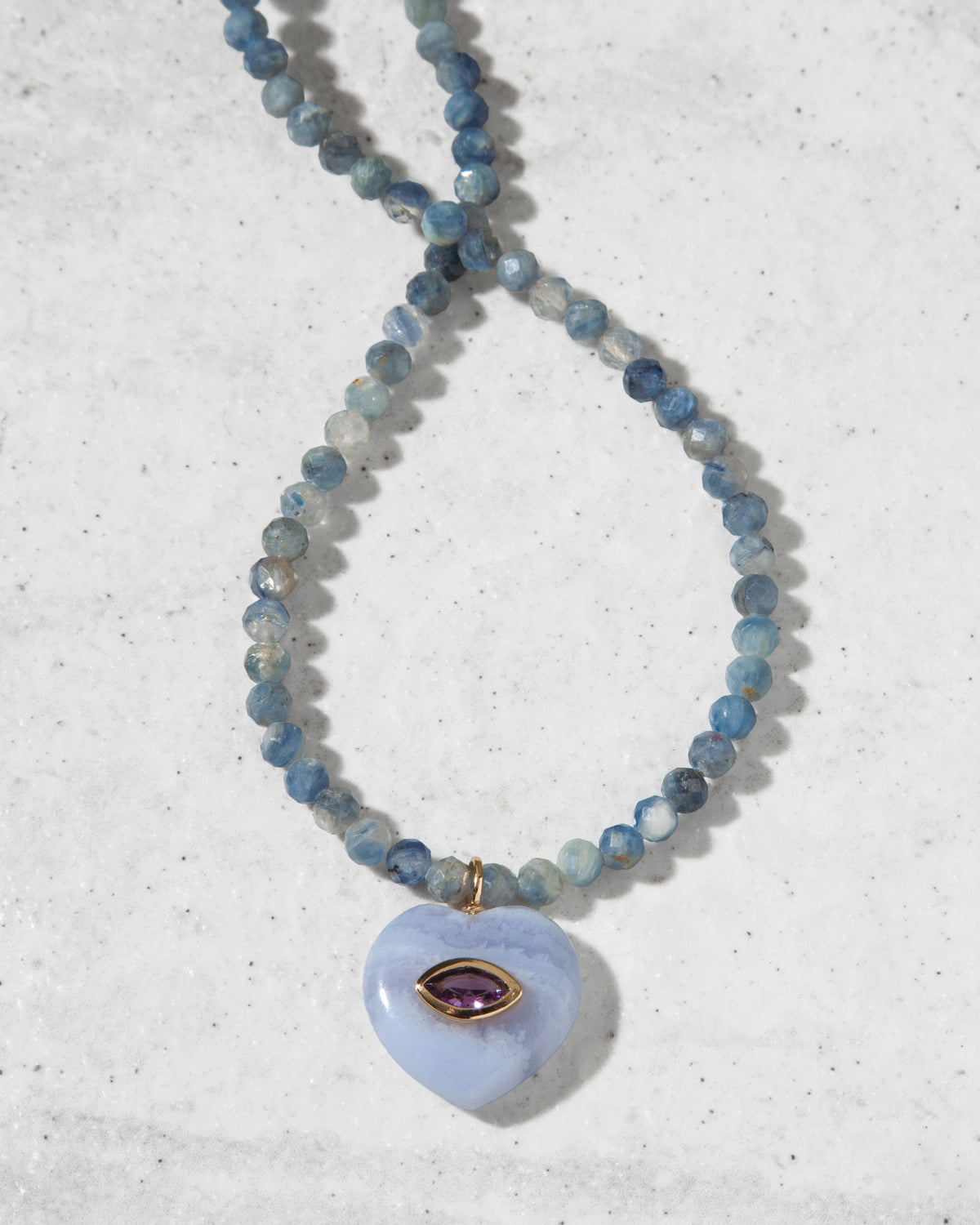 Kyanite beaded gemstone with blue lace agate heart pendant necklace closeup.