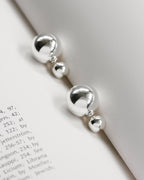 Silver front-back earrings with a polished finish and orb backings