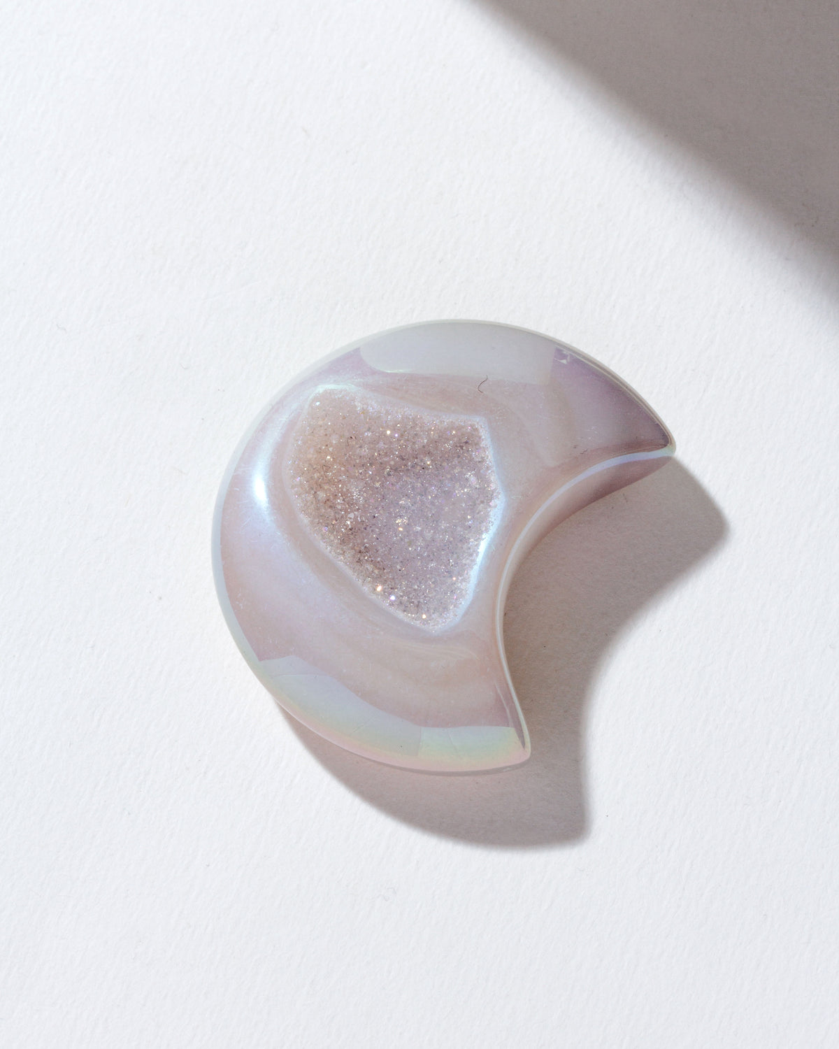Bright colored druzy agate moon shaped gemstone curio.