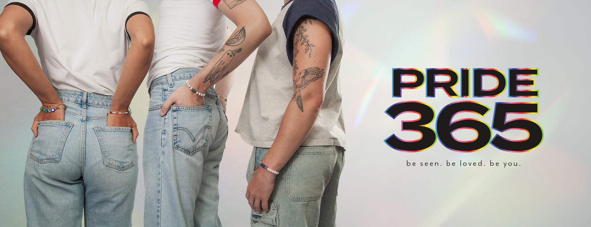Three people in jeans wearing stretch bracelets and text "Price 365, be seen, be loved, be you."