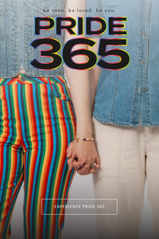 Two people holding hands for 'Pride 365' wearing matching denim and rainbow striped pants, "PRIDE365 be seen. be loved. be you." and a text button that reads "Experience Pride 365"