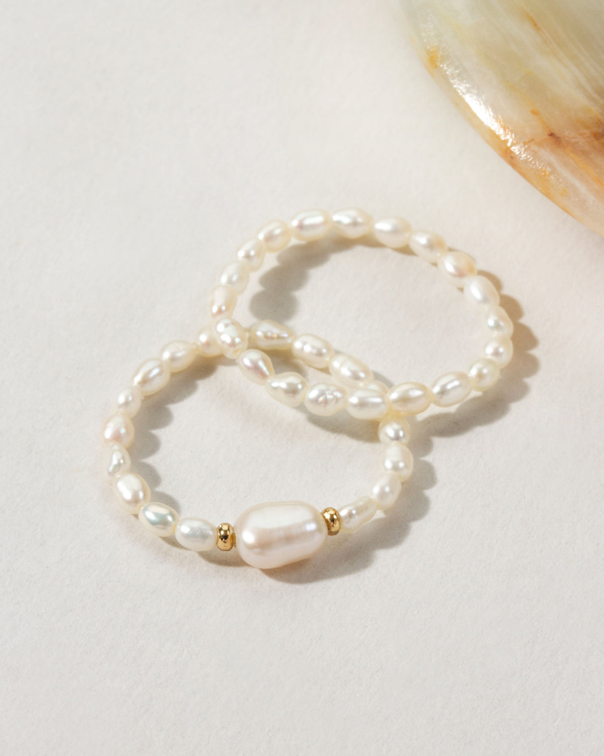 Two Coastal Stretch Rings, one with a Freshwater Pearl.