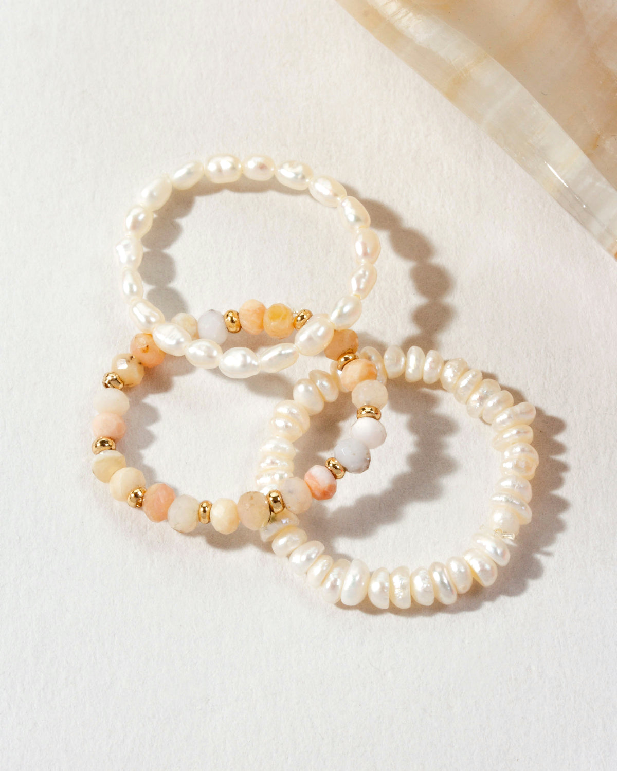 Three pearl and Peruvian Opal "Change Of Tides Stretch Ring" sets.