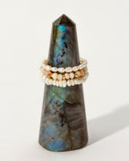 Three stacked, stretchy rings with pearls and Peruvian Opal beads on a Labradorite tower.