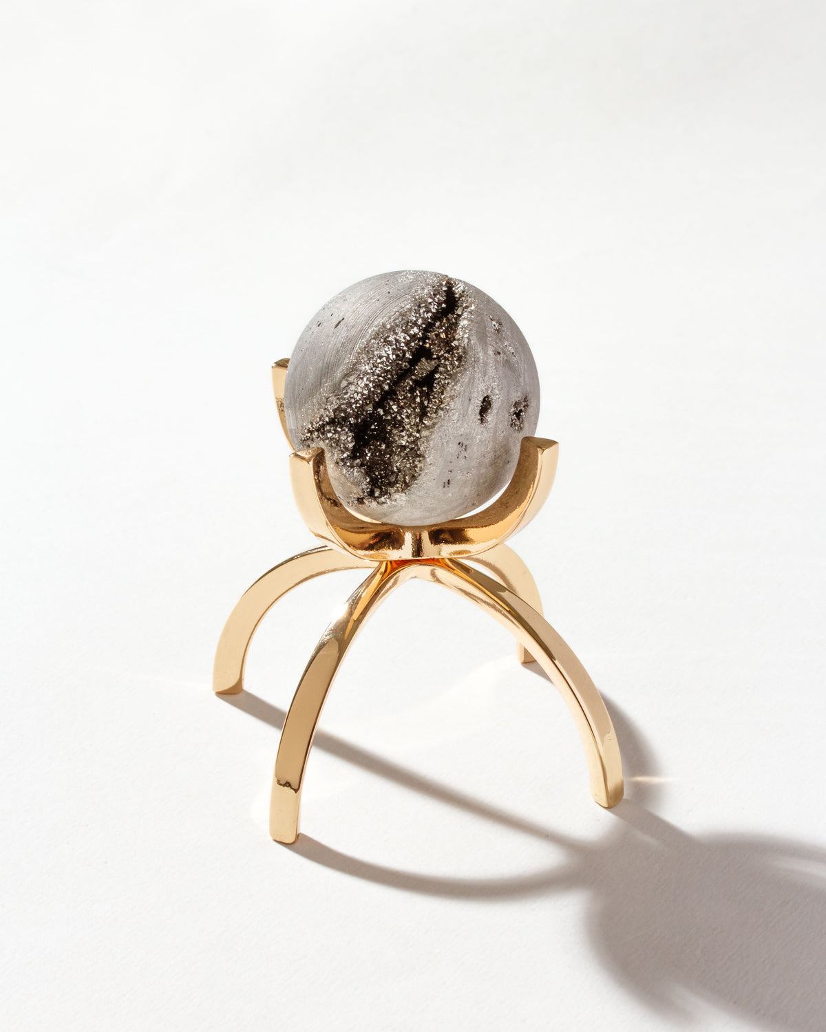 Silver Eye of the Beholder Druzy Gemstone Sphere on a Gold stand.