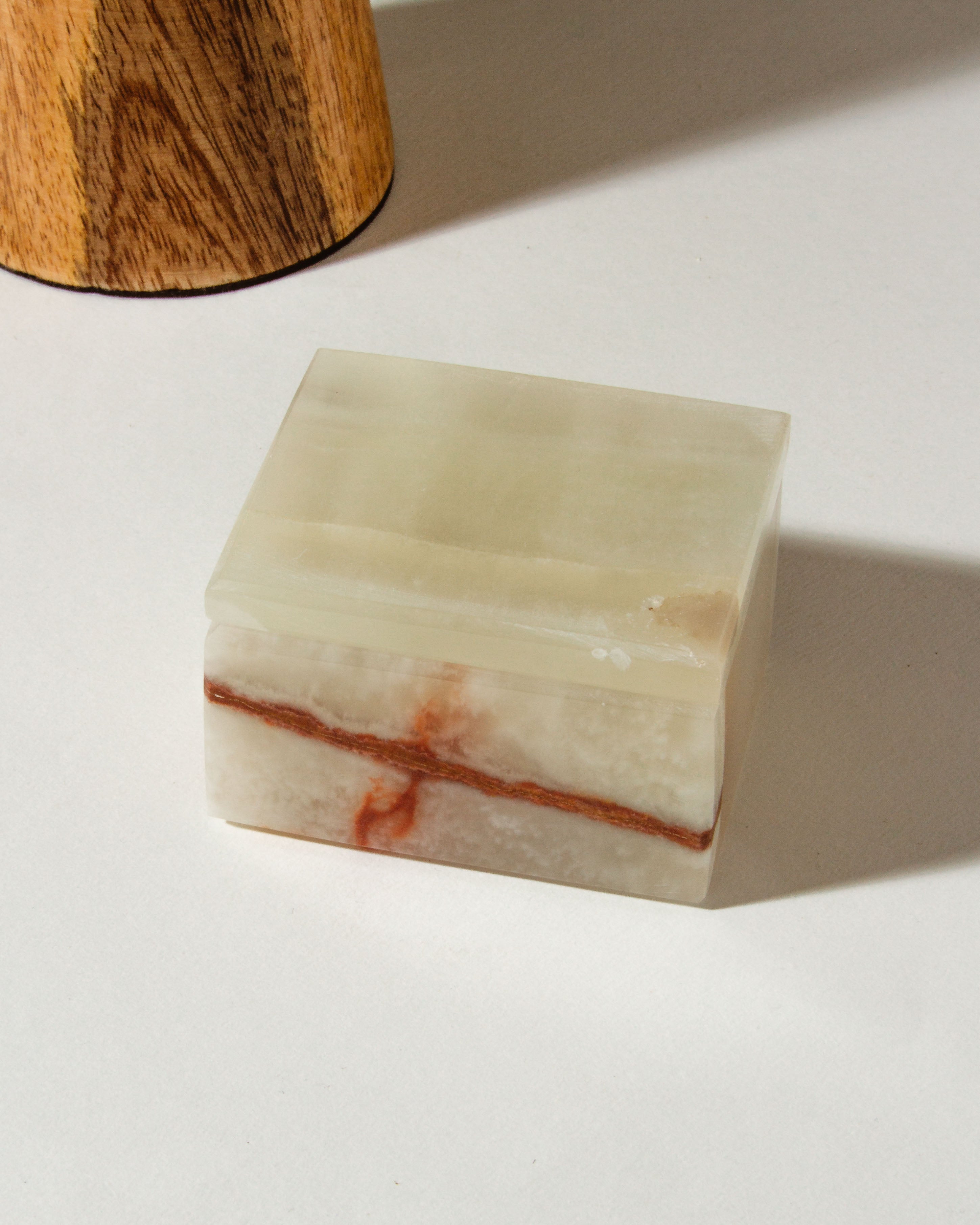 Calmly Organized Calcite Jewelry Box in white with a brown band on a white background.
