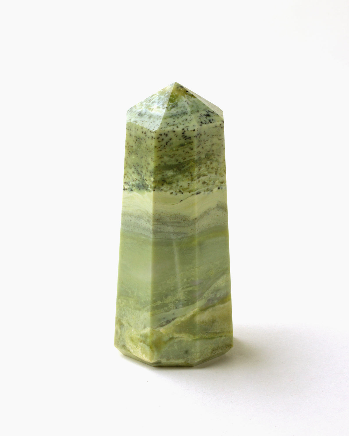 Serpentine Tower with a light green coloring and distinct layering on a white background.