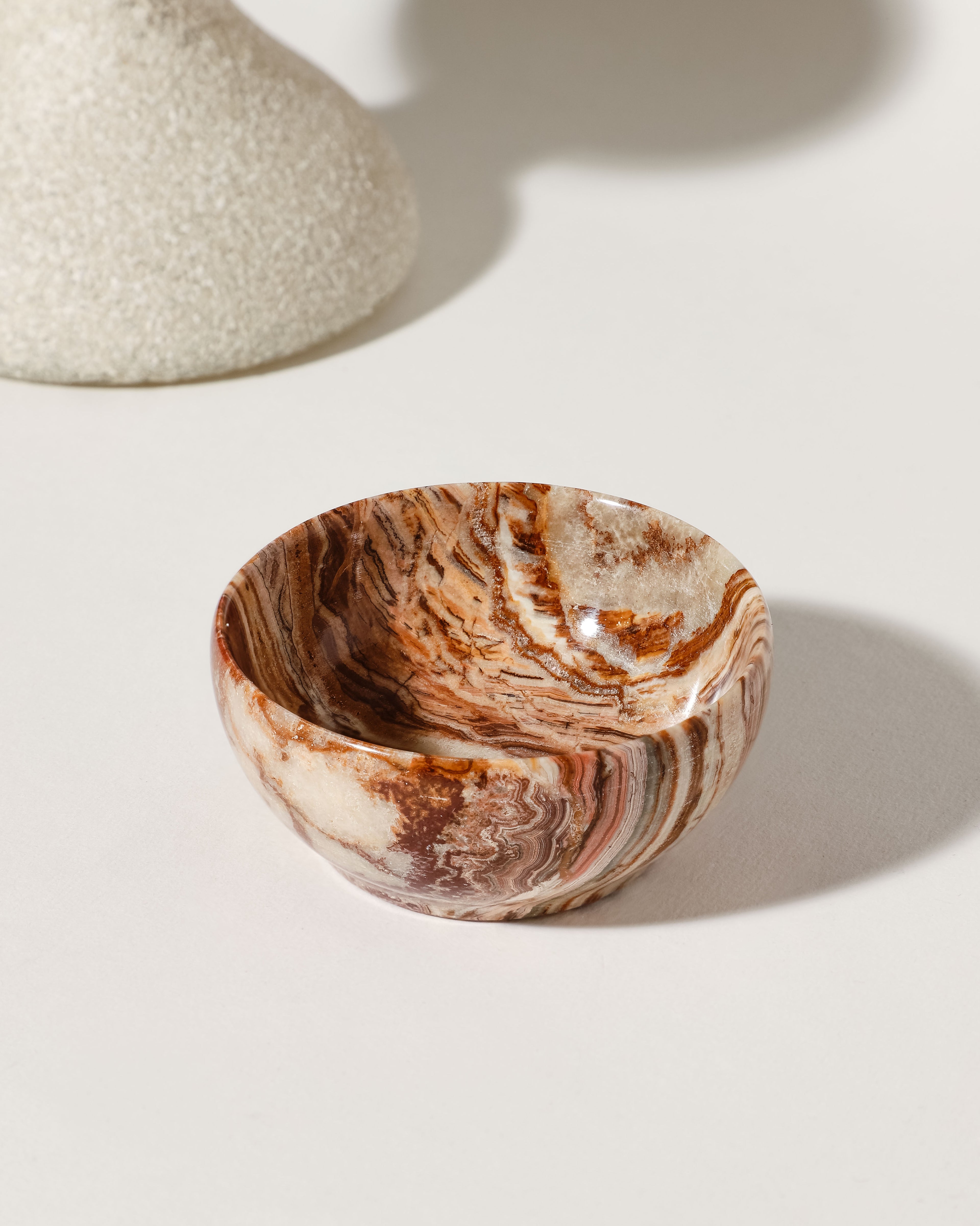 Calcite jewelry bowl displays brown and cream swirls